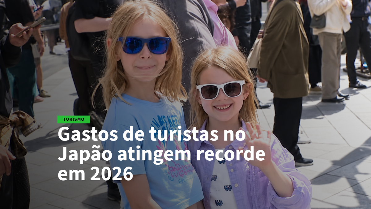 Two smiling girls in sunglasses posing in a sunny crowd on a city street.